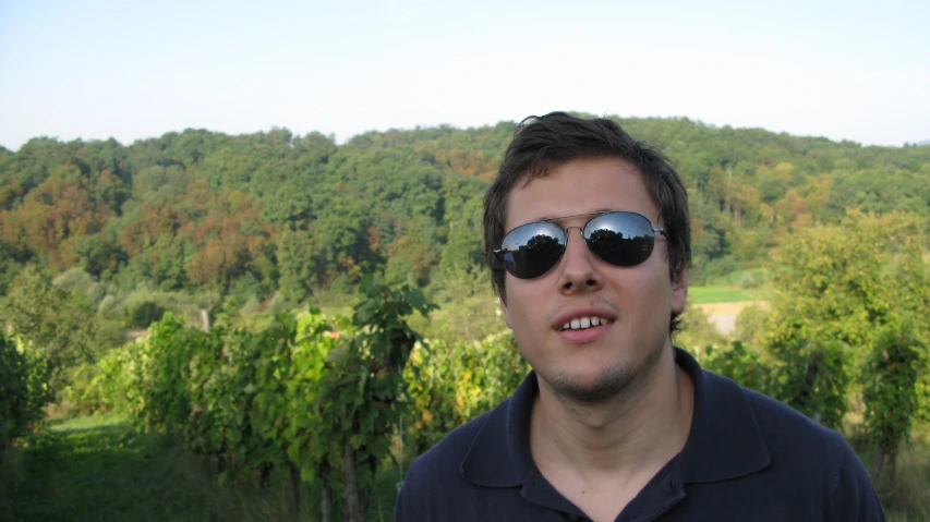 a man in a black polo shirt with sun glasses