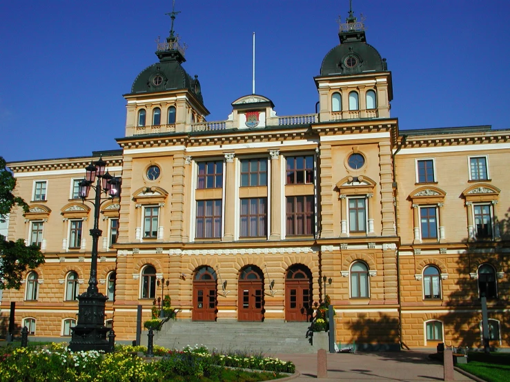 an old style building is surrounded by green bushes