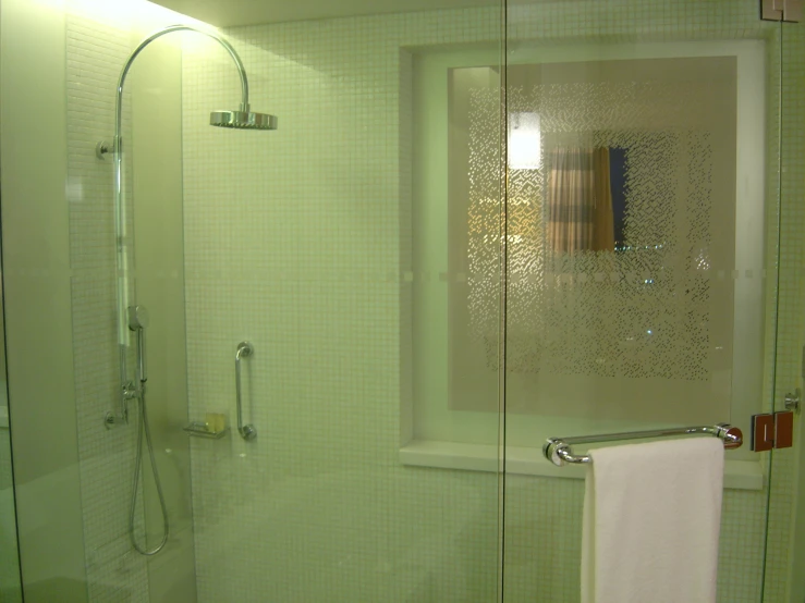 a bath room with a glass shower door