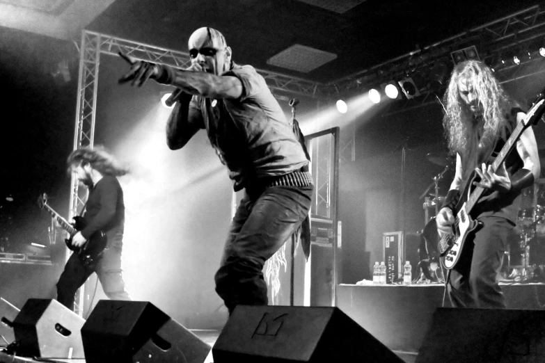 four men are performing at a concert on stage