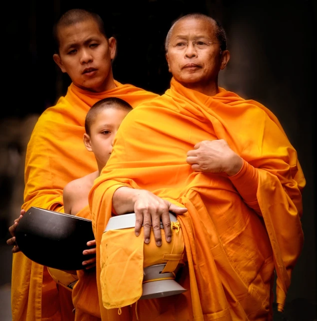 a couple of monks sitting in chairs next to each other