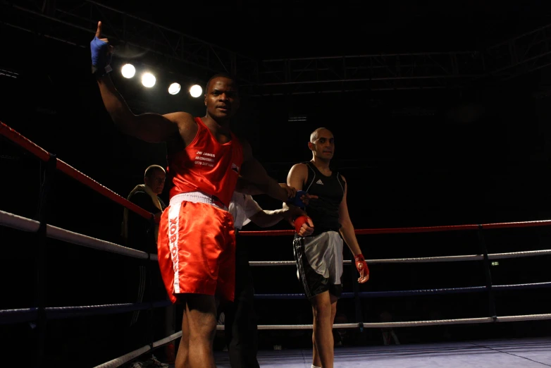 a man in a ring throws a ball to an unknown person