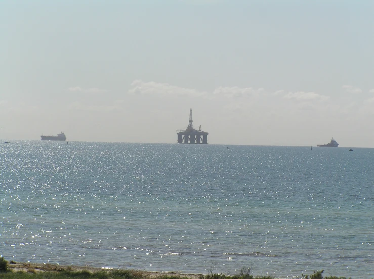 ships sit in the ocean on an overcast day