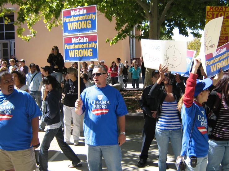 the group of people are holding signs in protest