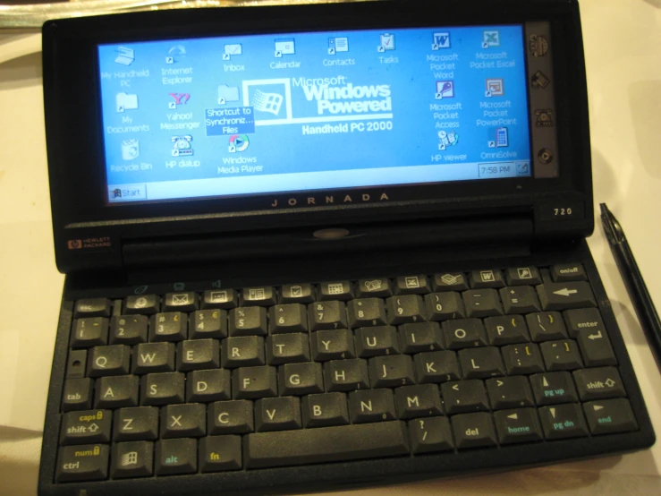 an open tablet that is sitting next to a keyboard