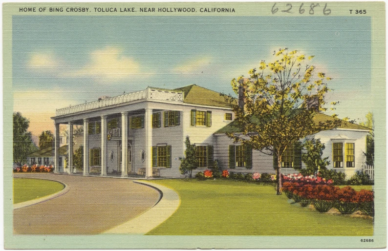 an old fashioned building with a large tree in front