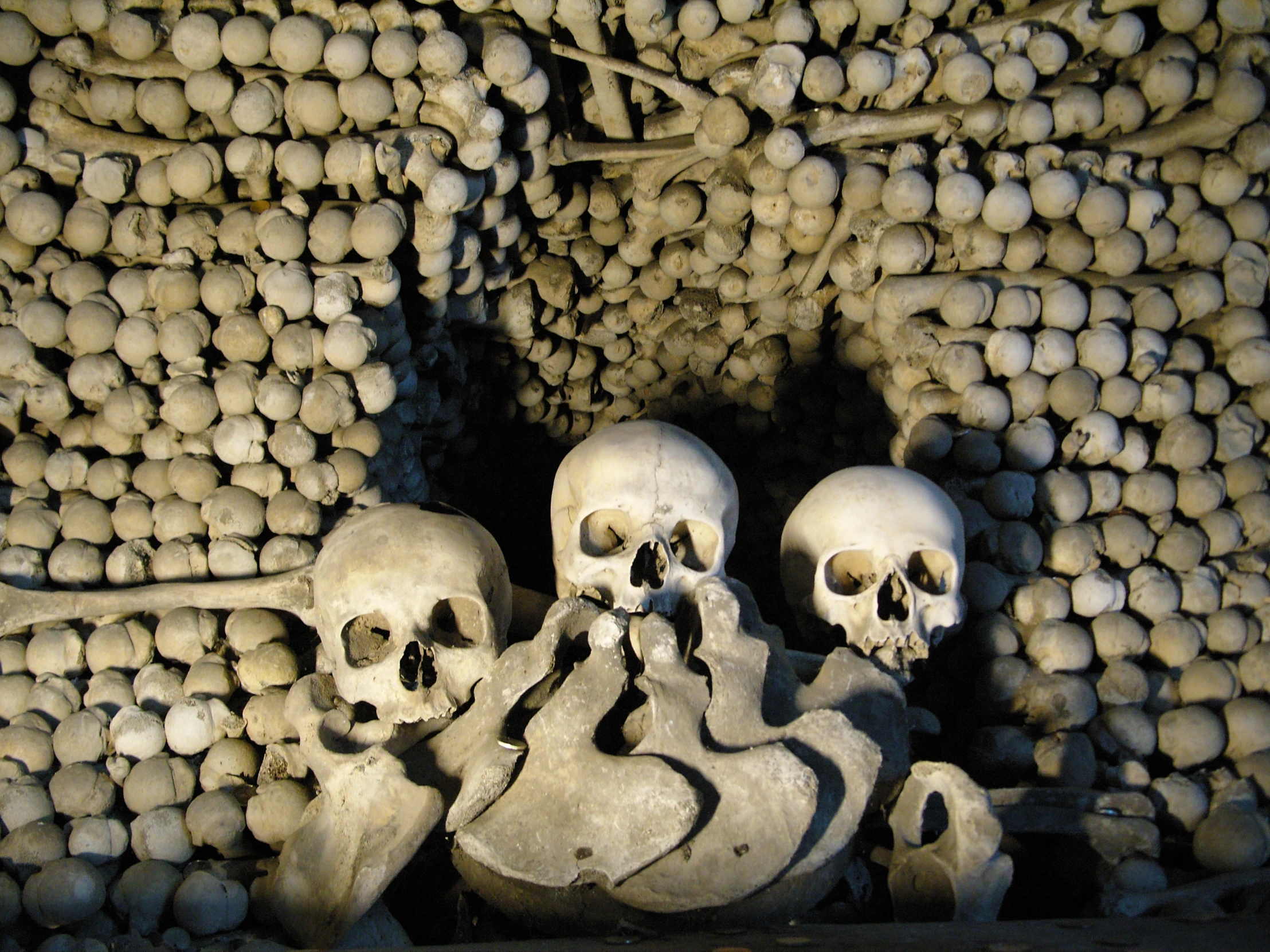 large stacks of skulls all stacked up in a pile