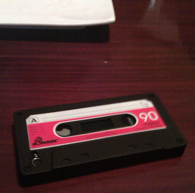 a pink cassette is sitting on the table