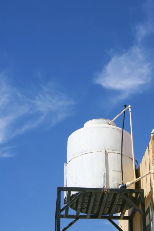 a big white tank next to a building