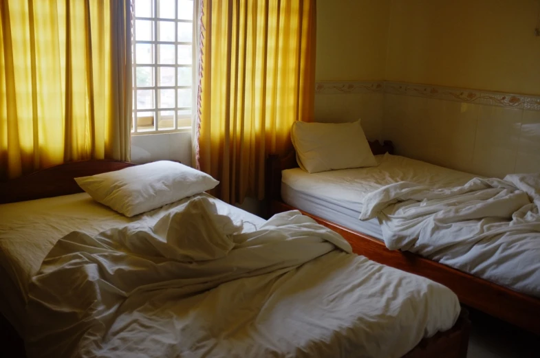 a couple of beds sitting inside of a room