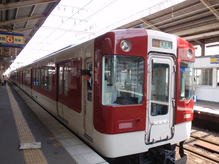 red and white train in the station at dusk