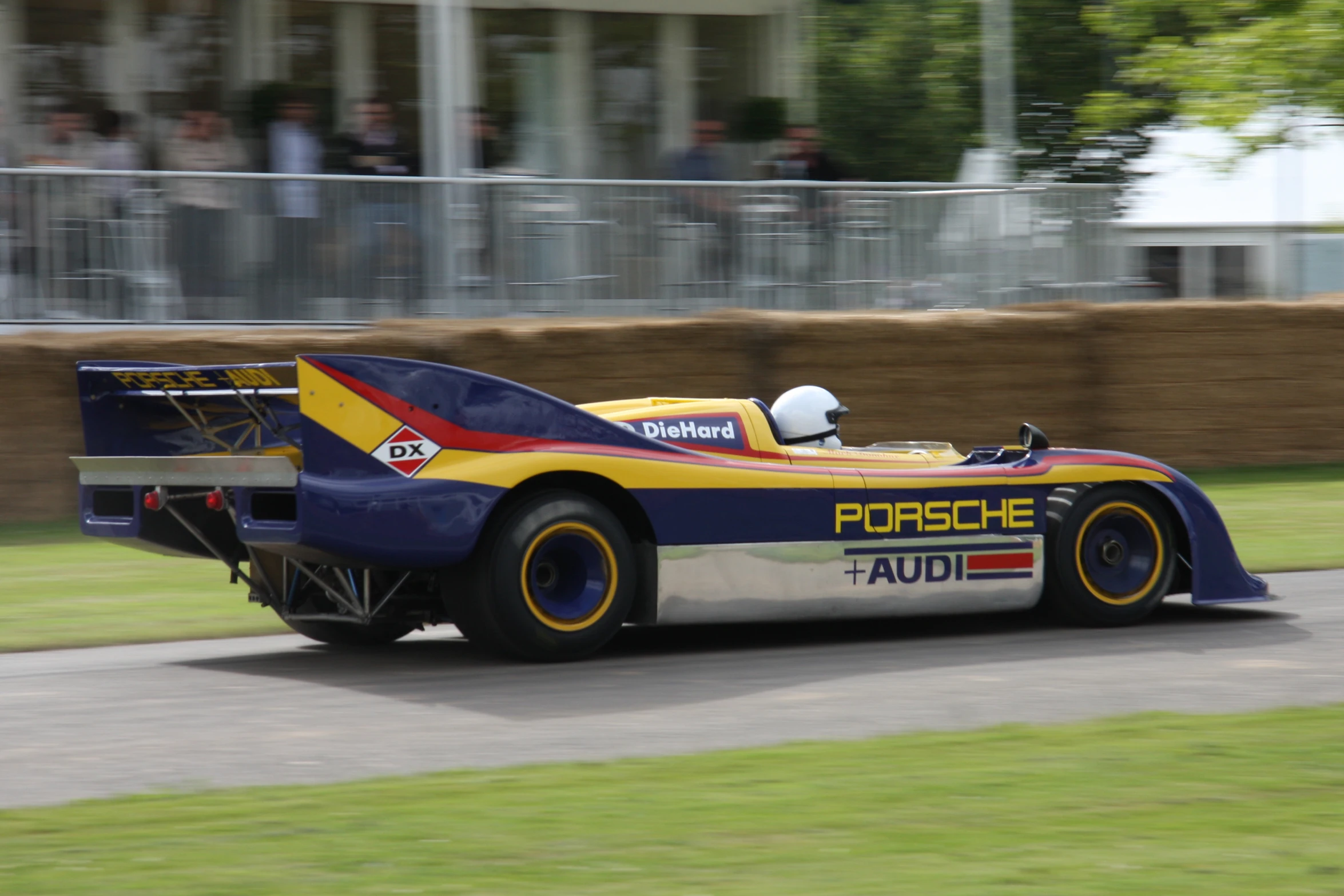 a race car speeding on the track during the day