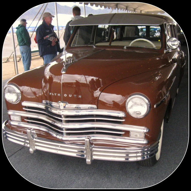 an old - fashioned brown car is sitting on display