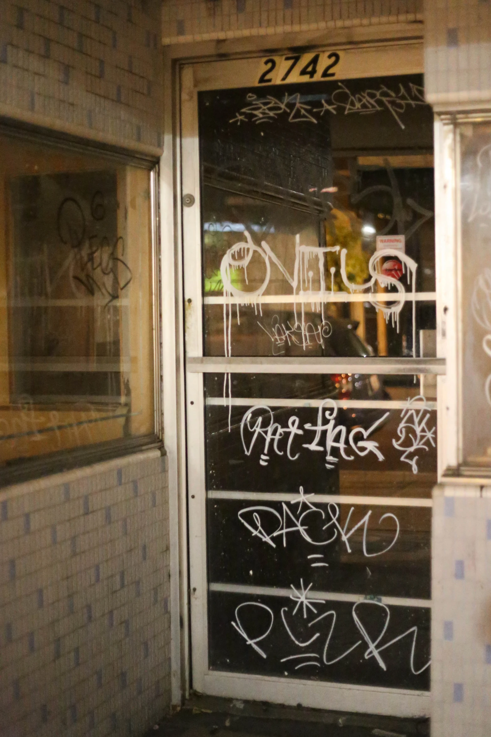 a building that has graffiti writing all over the door