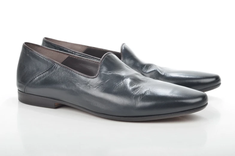 black loafer with a pointed heel, which features metallic detailing and leather soles