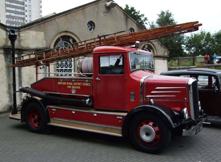 an old firetruck parked in front of a church