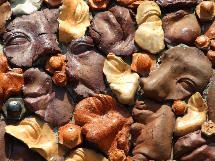 brown and yellow clay faces with some other shapes