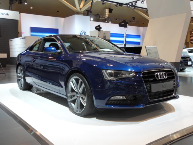 the blue audi car is parked on display