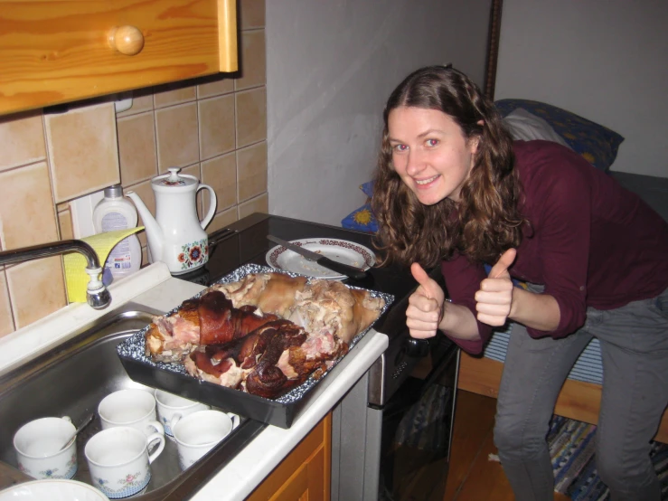 a woman gives the thumbs up while getting her dinner