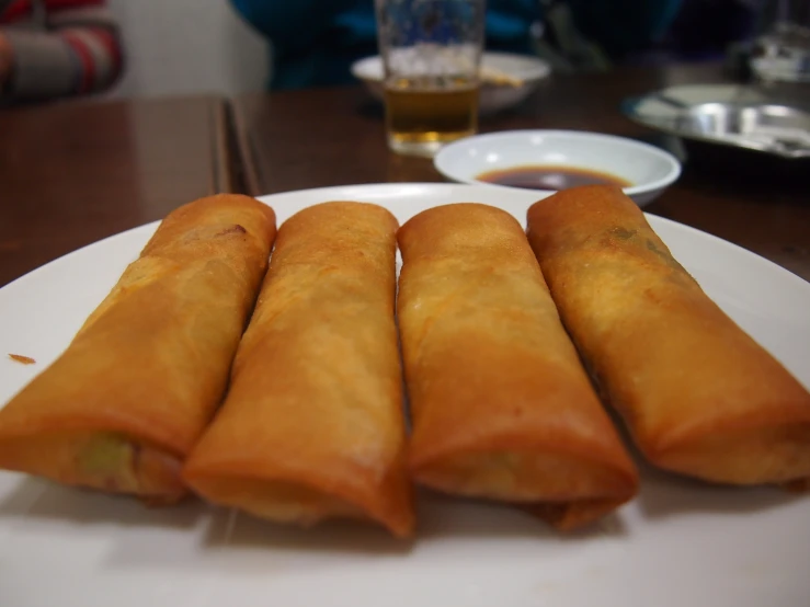 four empanade roll's lined up on a plate