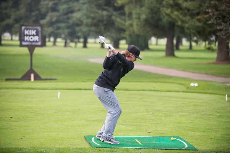 a man swinging his bat while holding a golf club in his hand