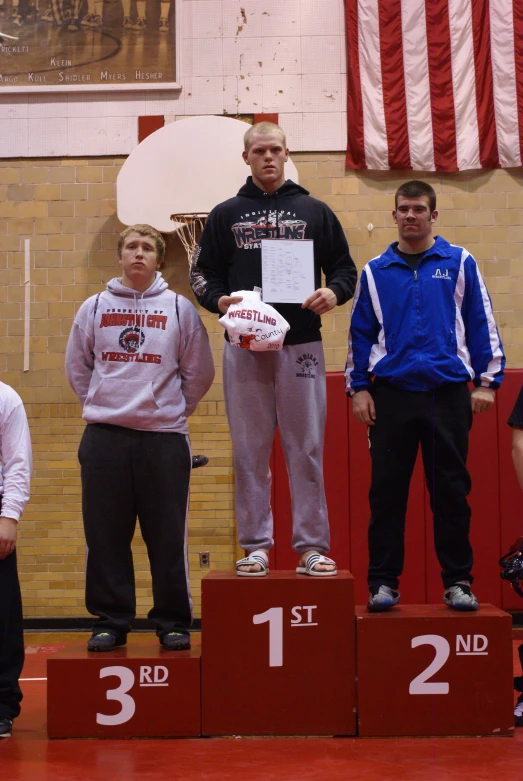 a man stands on the podium with some s standing beside him