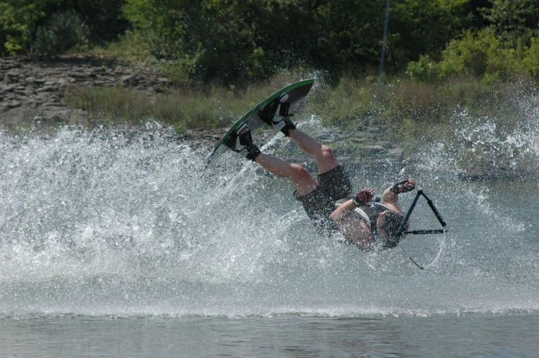 a man falling in the water while surfing