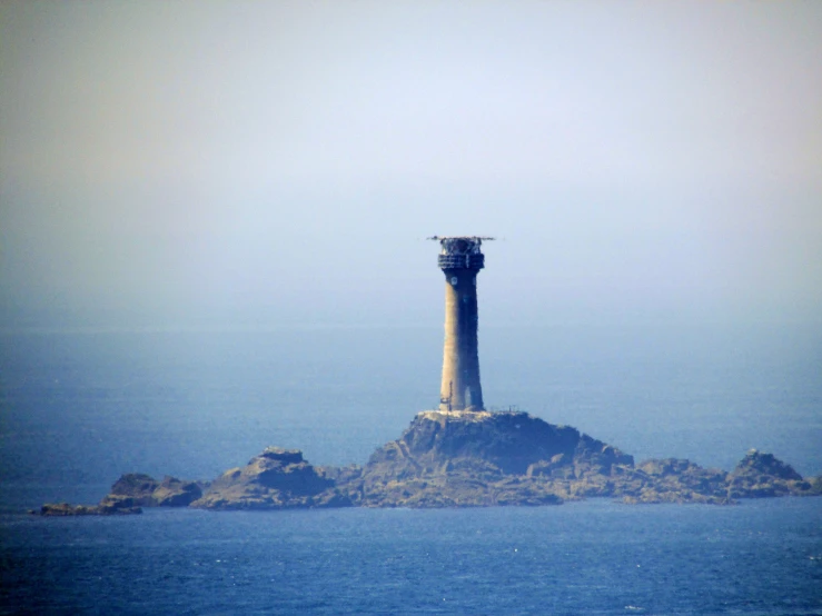 an island with a lighthouse in the middle of it