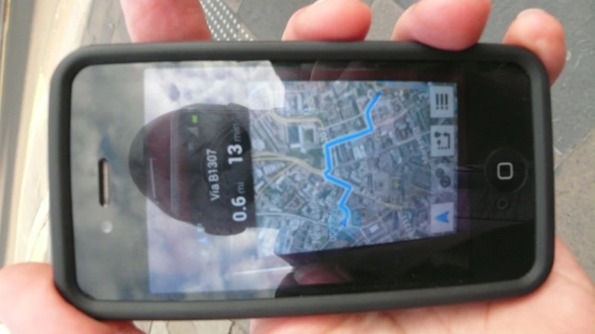 someone holds a cellphone up to show the map