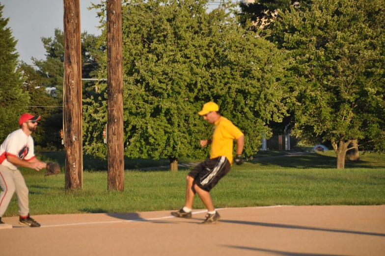 two guys with yellow caps are on skate boards