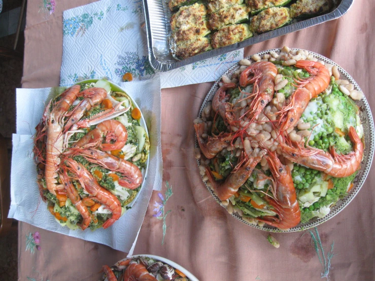 seafood on the table with plates and trays