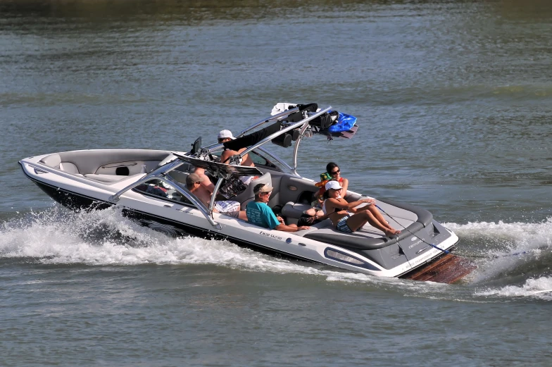 a motorboat sailing through water with people on it