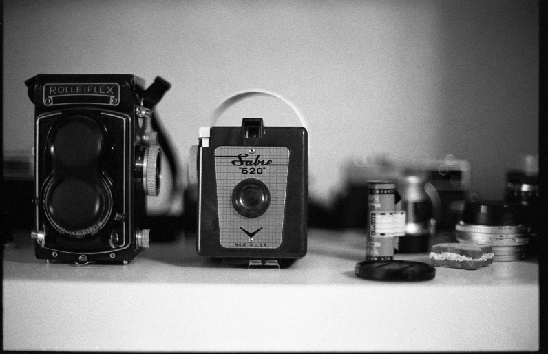 an old camera and other items are sitting on the table