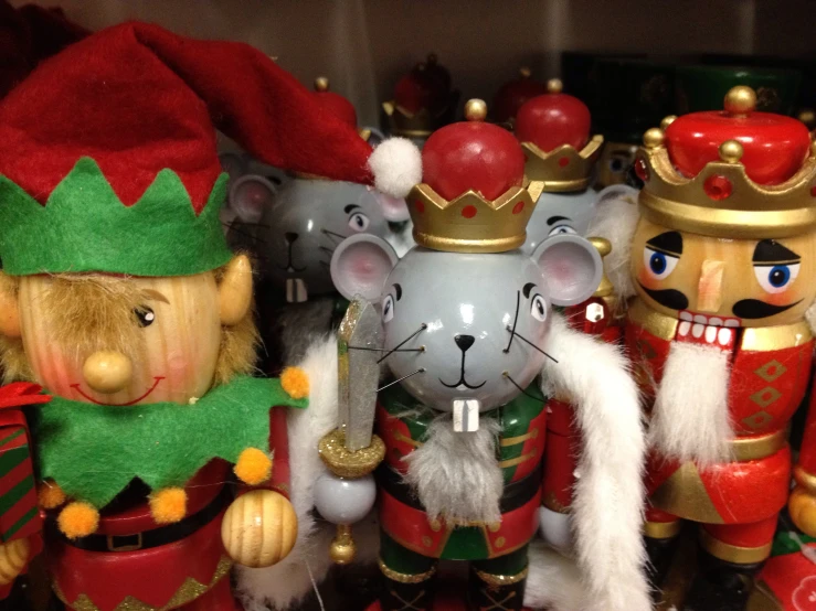 some toy mice are dressed up in christmas gear