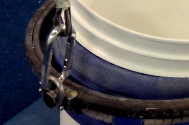 a stack of white and blue containers with chains on them