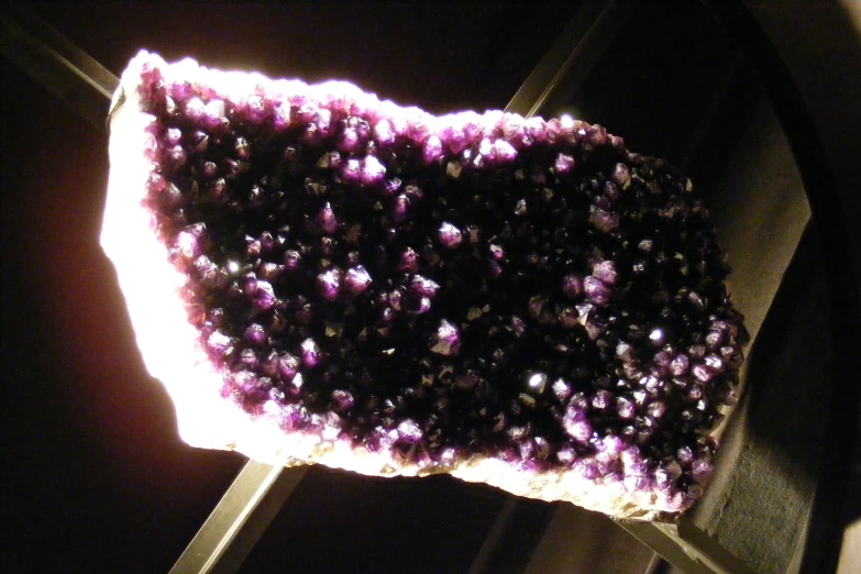 a piece of white cake that is covered with dark purple frosting