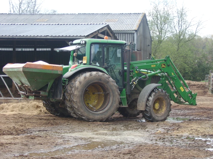 the tractor is parked outside on the dirt