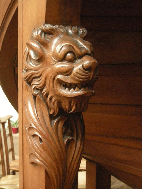 an elaborate wooden door handle with an animal head