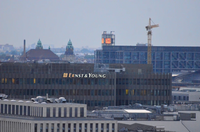 large glass building with clock and words on it