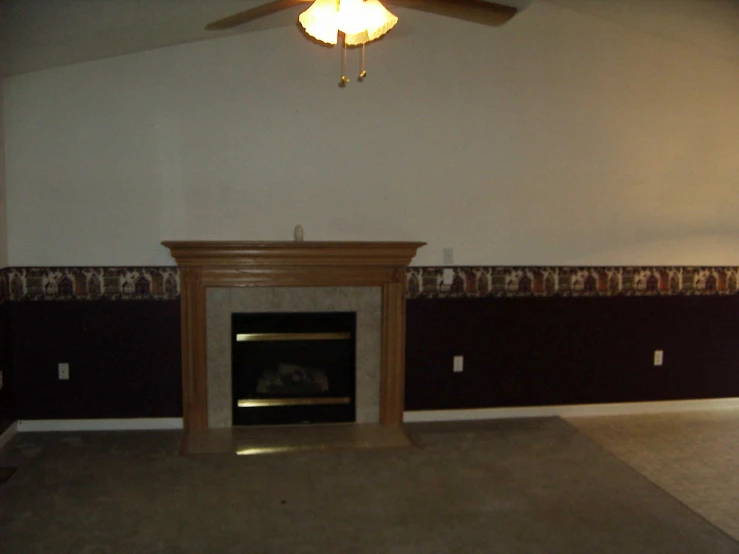 a living room with a fireplace and a ceiling fan