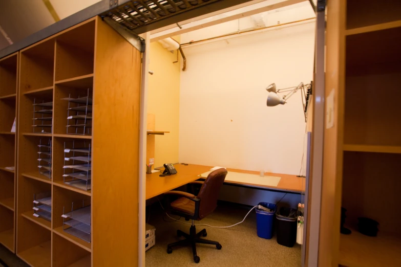 an office with bookcases, a desk and a chair