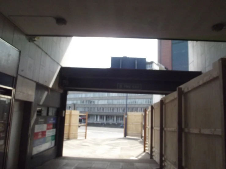 an open doorway to a building with buildings in the background