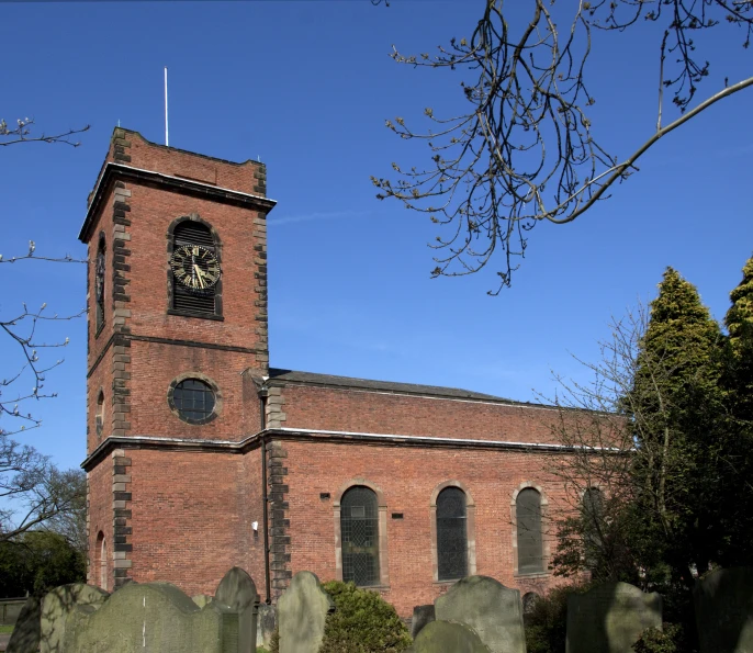 a church with a tall tower surrounded by tombstones