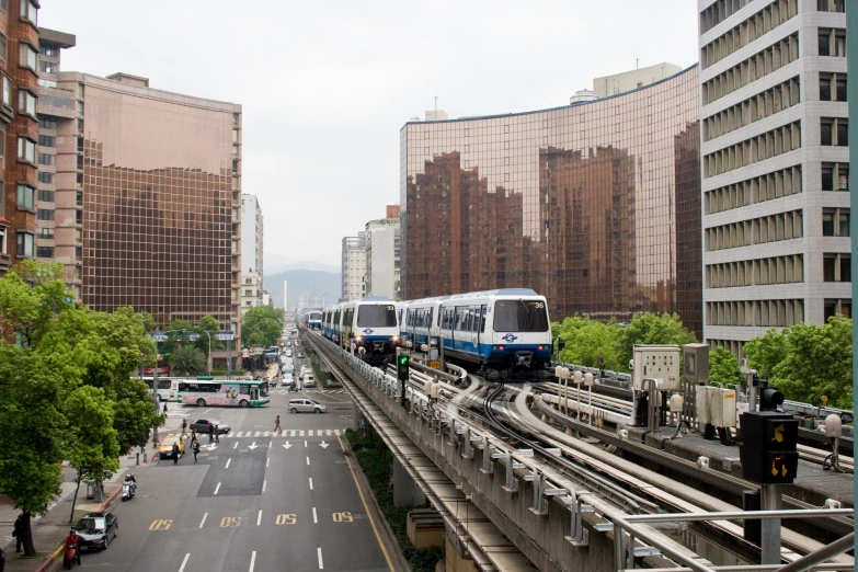 train track with trains passing through downtown area