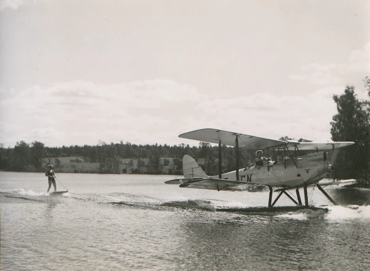 an airplane sitting on top of water near trees