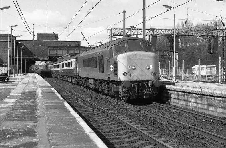 a train is pulling out into an open station