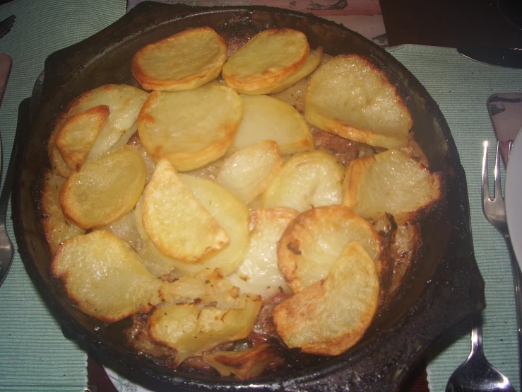 a pan filled with fried food on top of a table