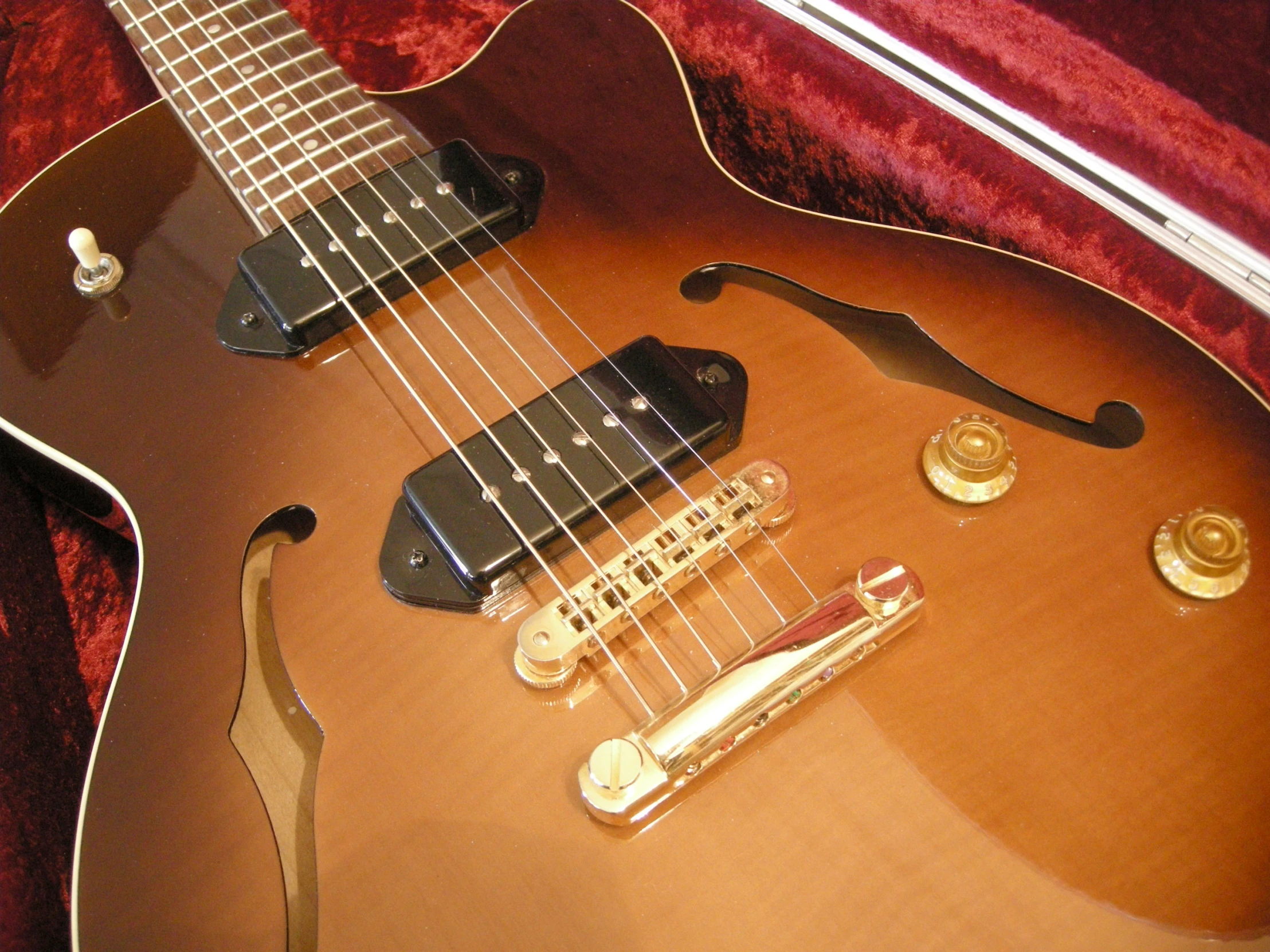 an intricate looking guitar in gold and brown