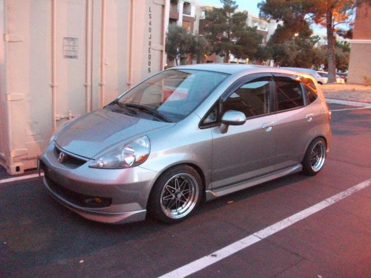 the metallic and chrome car is parked in a parking lot