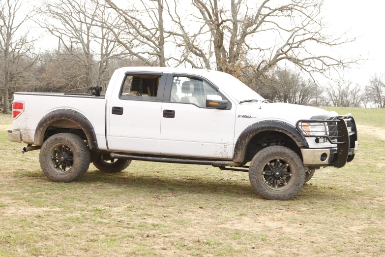 a white pick up truck parked in a field